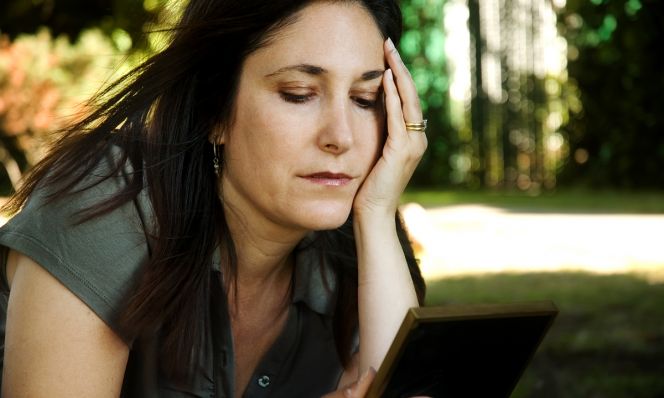 Mom looking at photo in picture frame