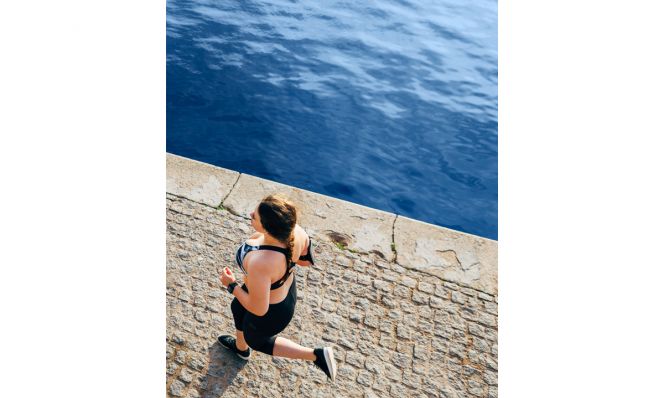 woman running on waterfront
